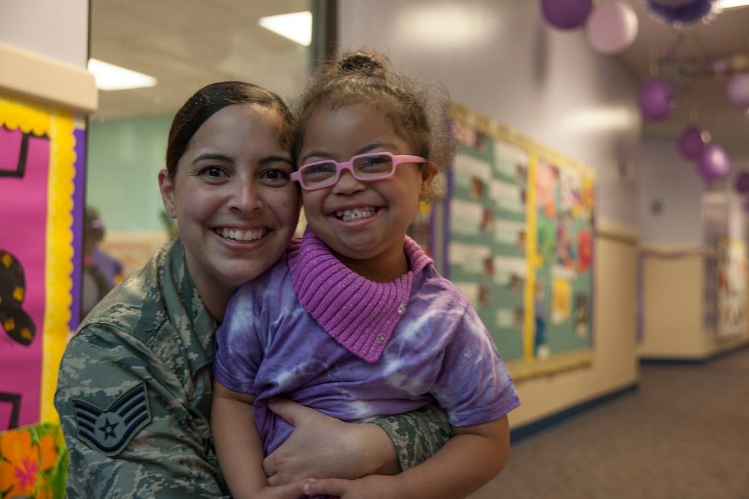 Staff Sgt. Yinell Covington, 779th Dental Squadron dental assistant, and her daughter, Maya Rosario, pose for a picture at a school parade at the Joint Base Andrews Child Development Center Three April 7, 2016. The parade kicks off Month of the Military Child, a time to honor military youth for the important role they play in contributing to the strength of the military family. (U.S. Air Force photo by Airman 1st Class Rustie Kramer/Released)