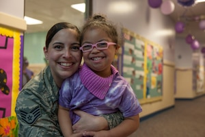 Staff Sgt. Yinell Covington, 779th Dental Squadron dental assistant, and her daughter, Maya Rosario, pose for a picture at a school parade at the Joint Base Andrews Child Development Center Three April 7, 2016. The parade kicks off Month of the Military Child, a time to honor military youth for the important role they play in contributing to the strength of the military family. (U.S. Air Force photo by Airman 1st Class Rustie Kramer/Released)