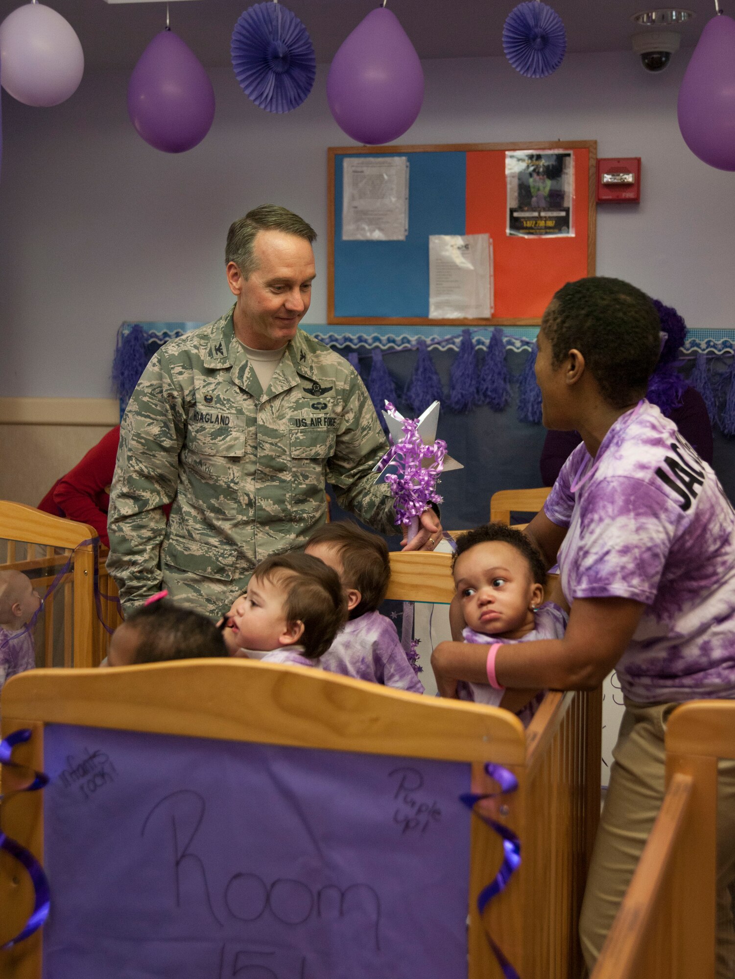 Col. Bradley Hoagland, 11th Wing/Joint Base Andrews commander, visits with staff and students before a “purple” parade at JBA’s Child Development Center Three April 7, 2016. The school parade kicks off the Month of the Military Child, a time to honor military youth for the important role they play in contributing to the strength of the military family. (U.S. Air Force photo by Airman 1st Class Rustie Kramer/Released)