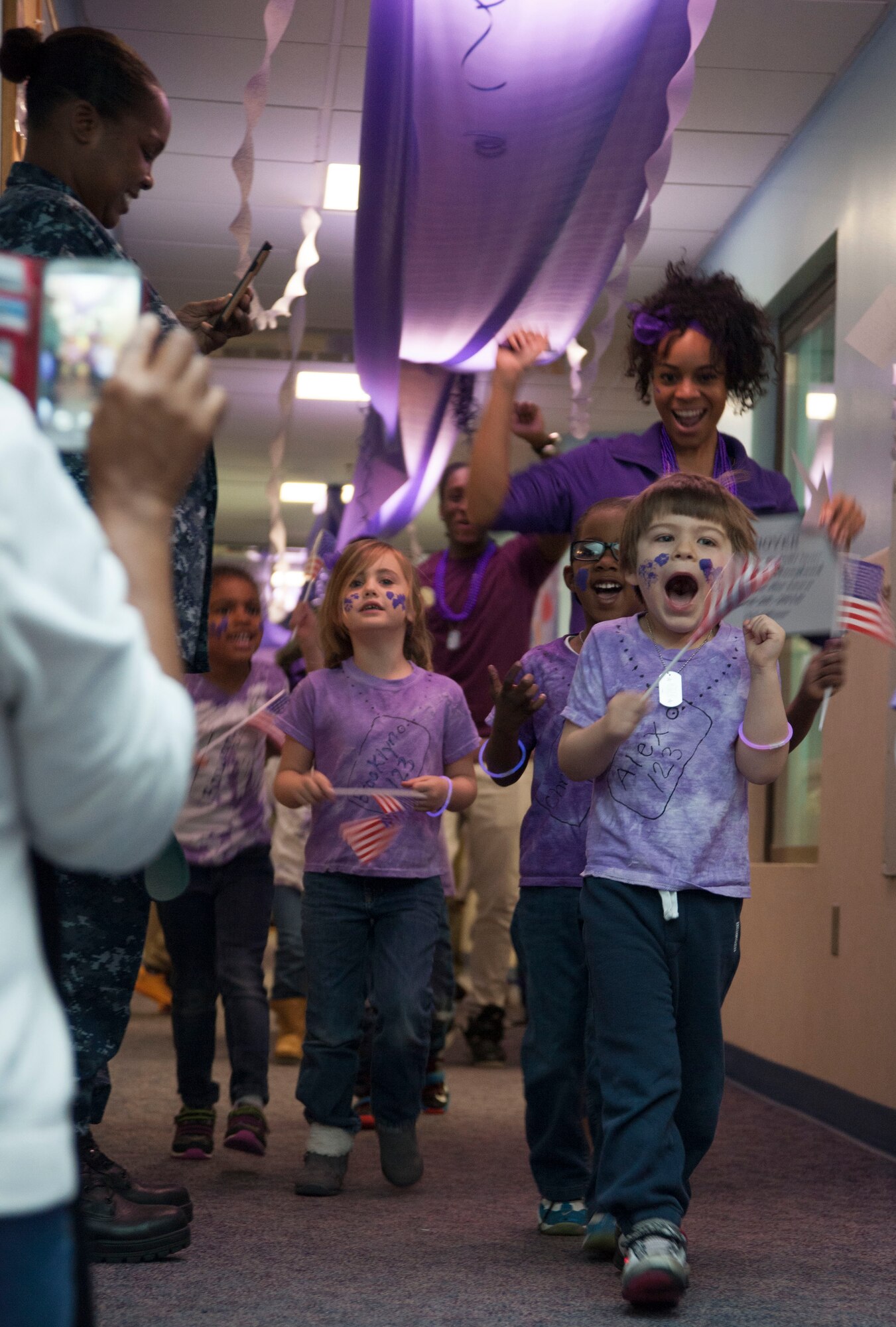 Students and staff of the Joint Base Andrews Child Development Center Three march in a “purple” parade April 7, 2016. The parade kicked off Month of the Military Child celebration, a time to honor military youth for the important role they play in contributing to the strength of the military family. (U.S. Air Force photo by Airman 1st Class Rustie Kramer/Released) 