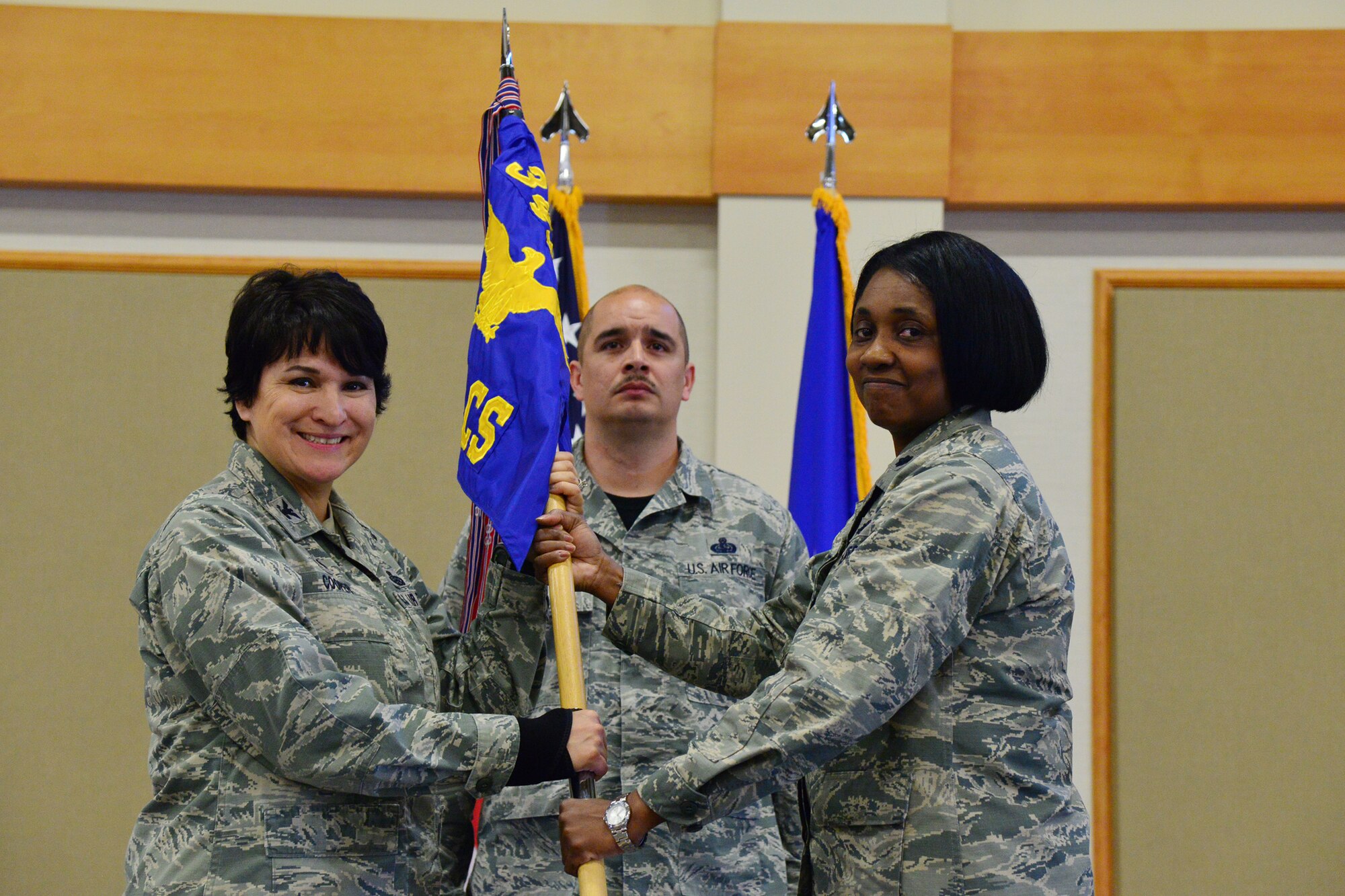 Lt. Col. Lashauna Lindsey, right, accepts command of the 341st Communications Squadron from Col. Denise Cooper, 341st Mission Support Group commander, during a change of command ceremony at the Malmstrom Air Force Base Grizzly Bend April 8. Master Sgt. Robert Verdugo, 341st CS operations flight chief, looks on. (U.S. Air Force photo/Airman Daniel Brosam)
