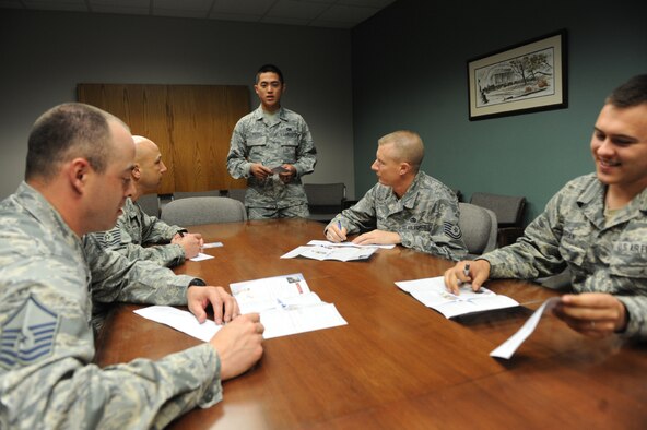 Airman 1st Class Jake LLarenas, 78th Logistics Readiness Squadron unit project officer, assists unit members with pledging their contributions to the Air Force Assistance Fund. (U.S. Air Force photo by Tommie Horton)