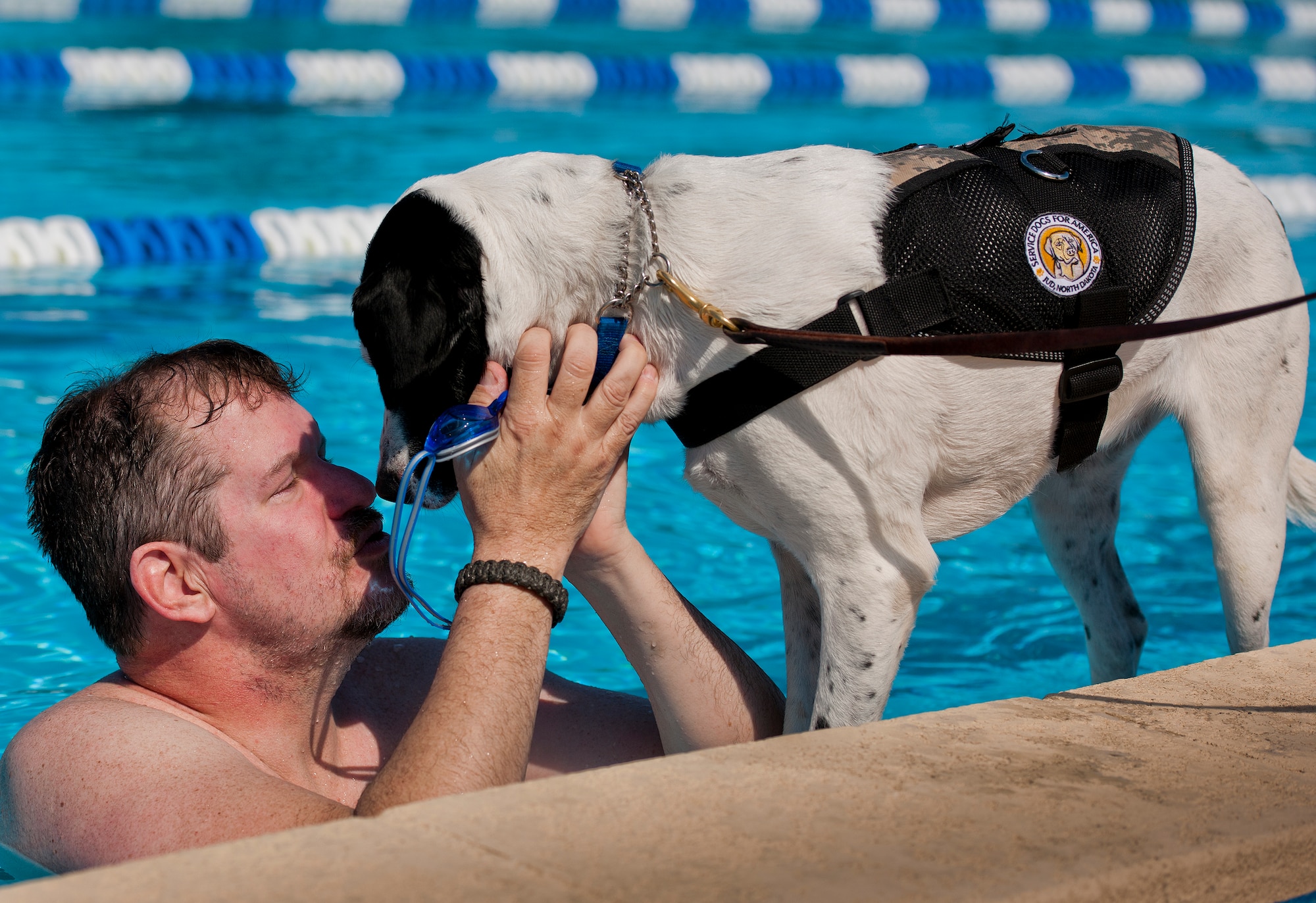 Lola greets her owner, Eric Fisher, a Warrior Care attendee, after a morning swim session at the adaptive sports camp at Eglin Air Force Base, Fla., April 7.  This was the first time Williamson returned to the pool after his leg amputation.  The base hosts the week-long Wound Warrior Care event that helps recovering wounded, ill and injured military members through specific hand-on rehabilitative training. (U.S. Air Force photo/Samuel King Jr.)