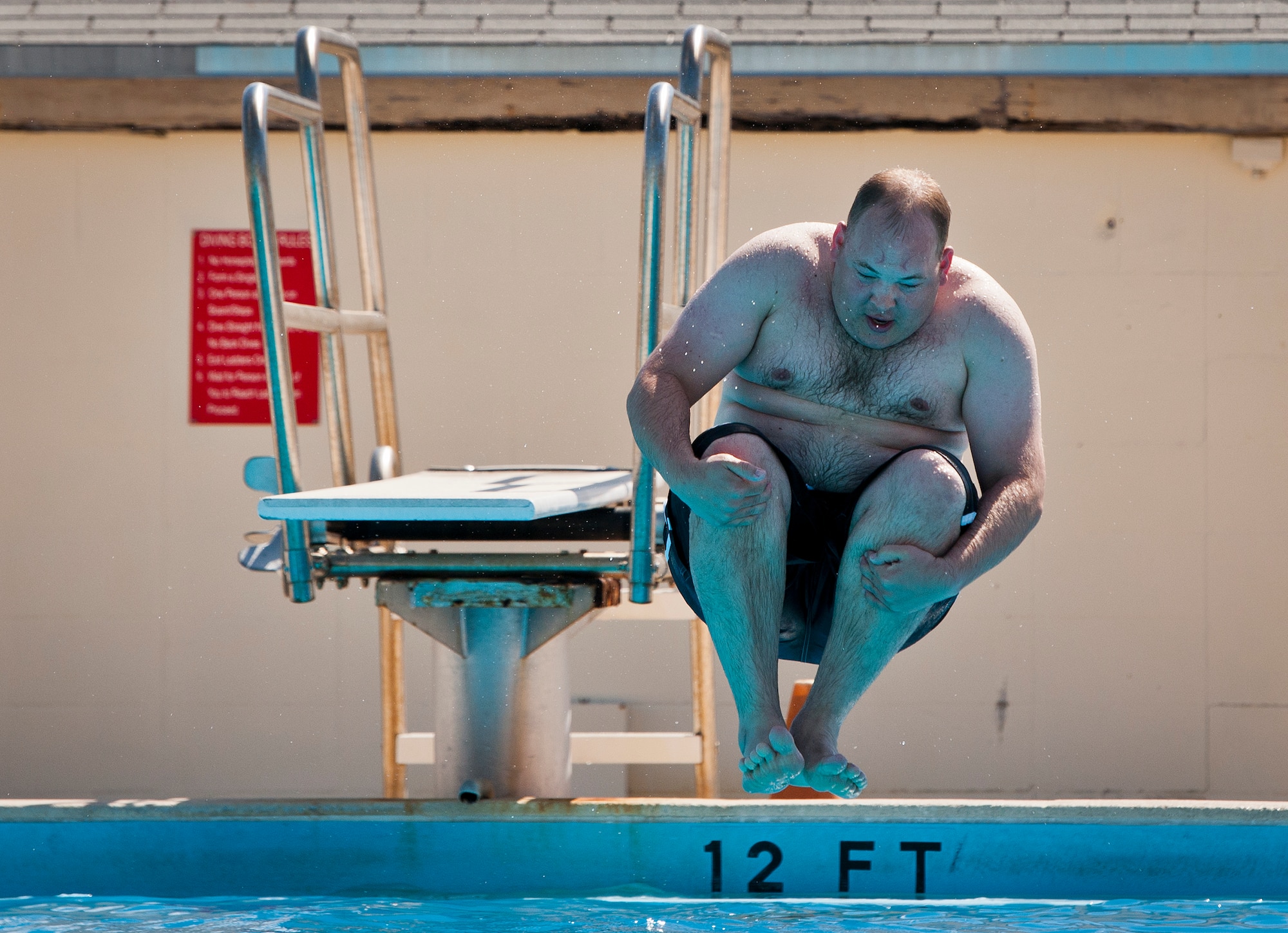 A Warrior Care attendee cannonballs off of the diving board during a morning swim session at the adaptive sports camp at Eglin Air Force Base, Fla., April 7.  This was the first time Williamson returned to the pool after his leg amputation.  The base hosts the week-long Wound Warrior Care event that helps recovering wounded, ill and injured military members through specific hand-on rehabilitative training. (U.S. Air Force photo/Samuel King Jr.)