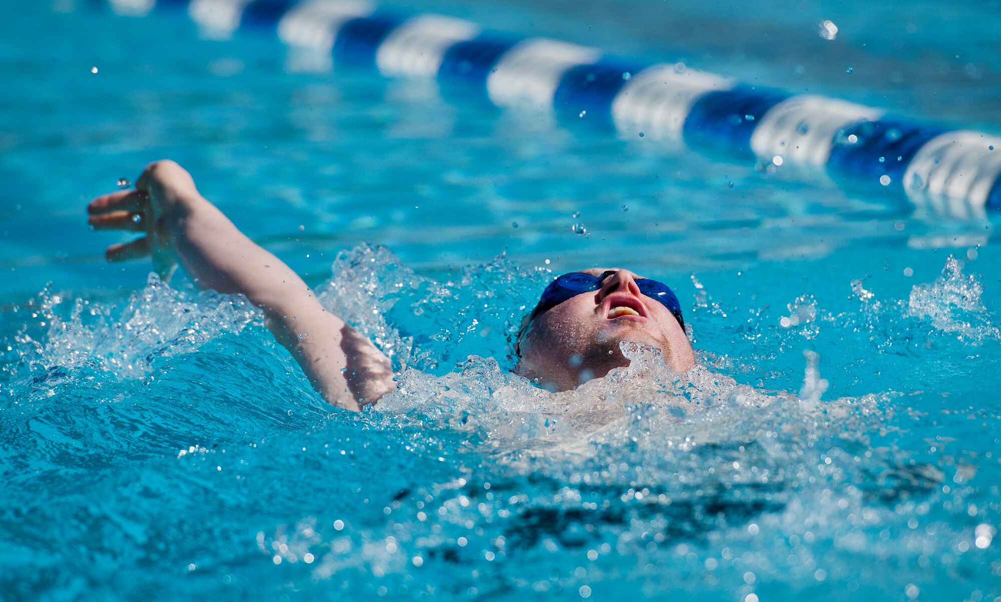 Austin Williamson, a Warrior Care attendee, practices his backstroke during a morning swim session at the adaptive sports camp at Eglin Air Force Base, Fla., April 7.  This was the first time Williamson returned to the pool after his leg amputation.  The base hosts the week-long Wound Warrior Care event that helps recovering wounded, ill and injured military members through specific hand-on rehabilitative training. (U.S. Air Force photo/Samuel King Jr.)