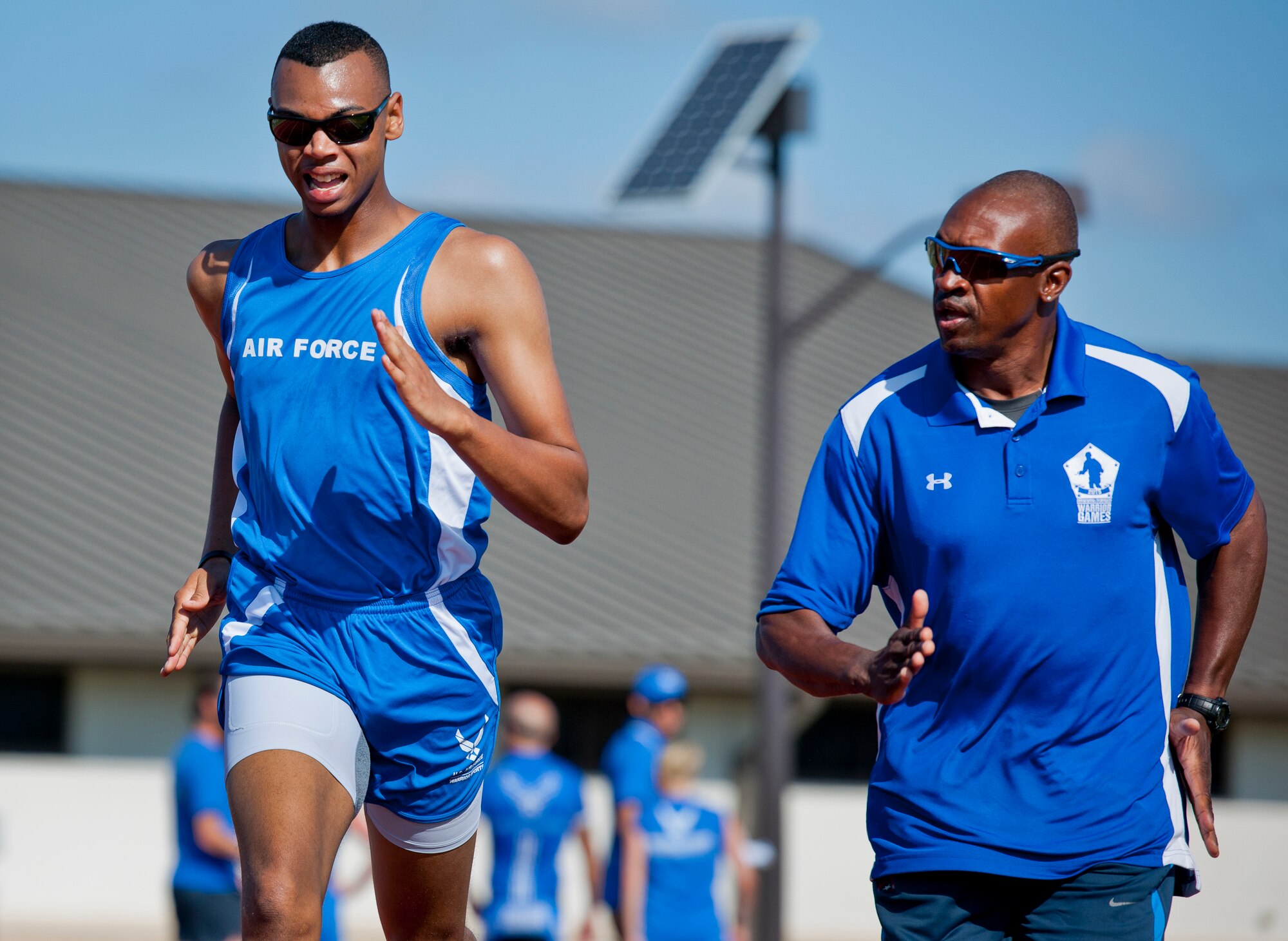 Trent Smith, a Warrior Games athlete, sprints with his coach, Eric Dickson, during a morning track and field session at the Air Force team’s training camp at Eglin Air Force Base, Fla., April 7. The base-hosted, week-long Warrior Games training camp is the last team practice session before the yearly competition in June. (U.S. Air Force photo/Samuel King Jr.)