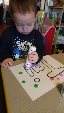 Tai, age 2.5, prepares artwork for the art expo, one of the activities being held in honor of April as Month of the Military Child at Wright-Patterson Air Force Base. Tai is in the care of Family Child Care provider Kelley Gump. (Contributed photo)