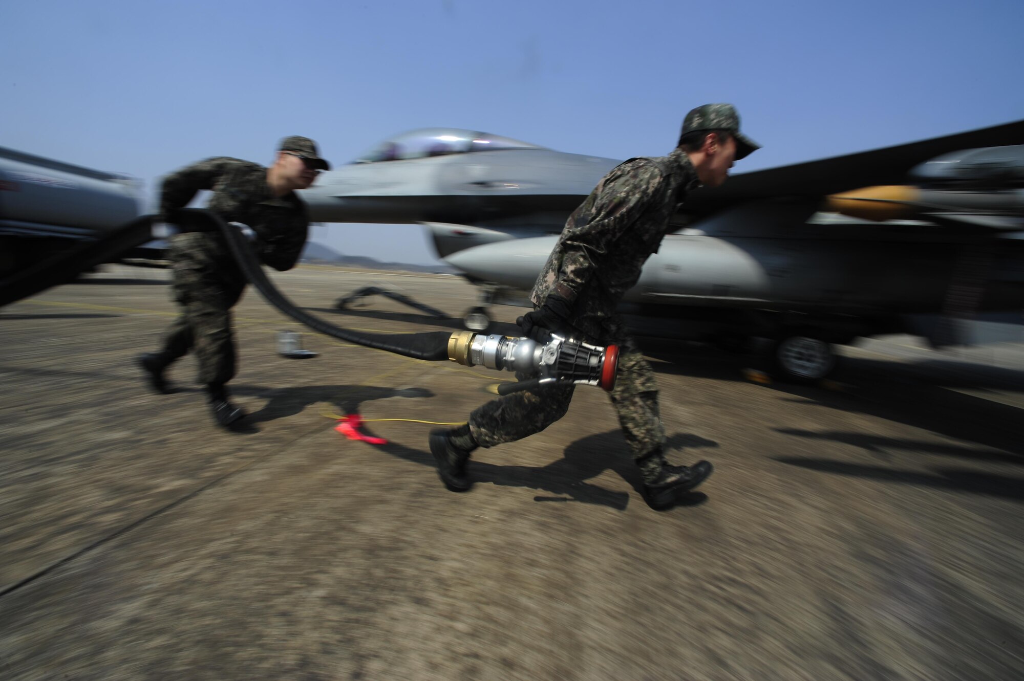 Republic of Korea air force Airman 1st Class Chang Kyu Park and Staff Sgt. Heon Kyun Jeon, both from the 19th Fighter Wing, carry aircraft equipment during Buddy Wing 16-3 at Jungwon Air Base, Republic of Korea, March 30, 2016. Buddy Wing training, held multiple times a year, polishes the ability of the Republic of Korea air force and U.S. Air Force Airmen to train and operate as a combined force. (U.S. Air Force photo by Staff Sgt. Nick Wilson/Released)