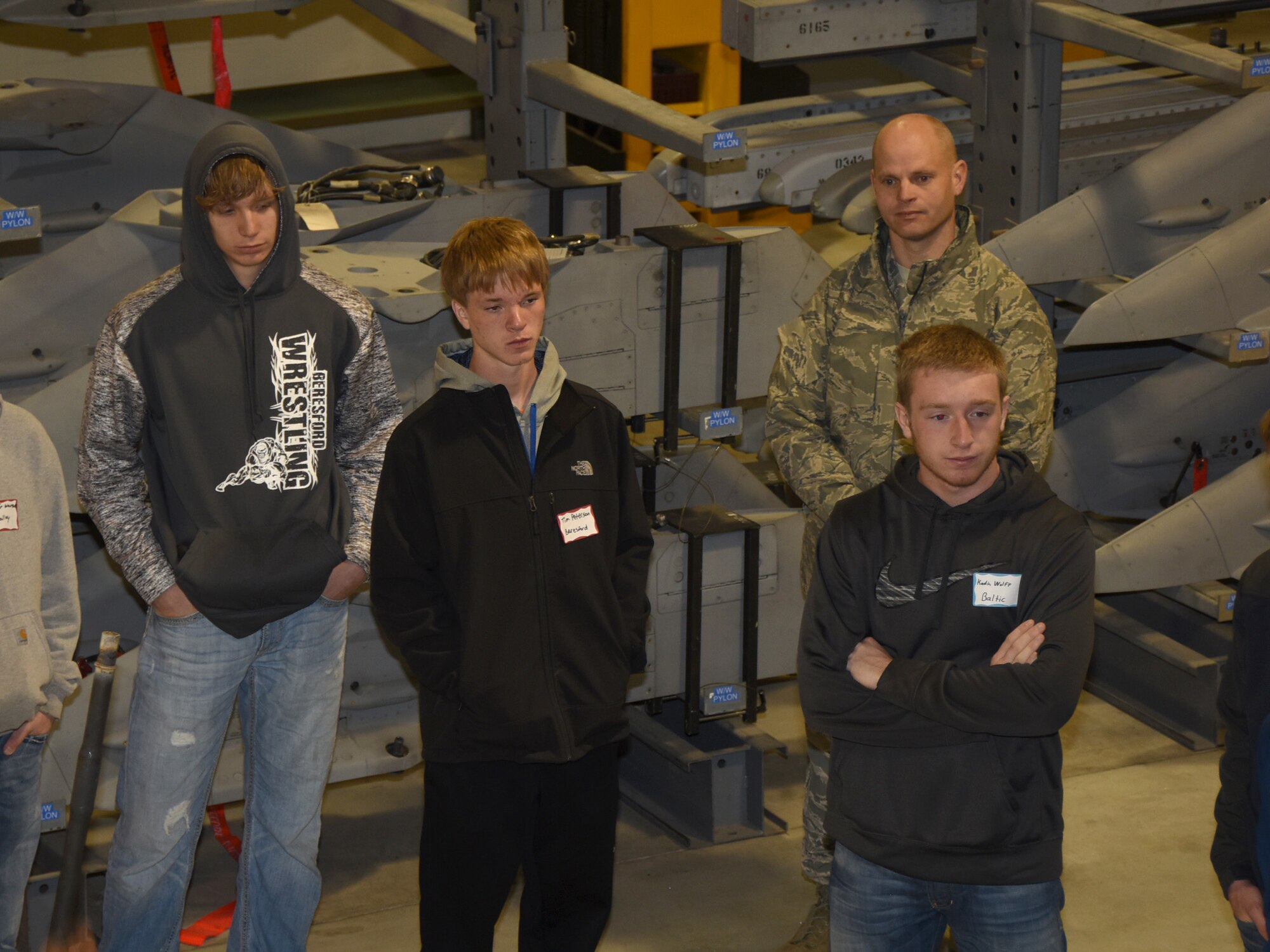 SIOUX FALLS, S.D. - Beresford, S.D. High School juniors, Lathen Norling and Tim Peterson, listen with other high school students as a weapons technician explains his career in the South Dakota Air National Guard during Career Day at Joe Foss Field, S.D. April 6, 2016.  Also pictured is Tim Peterson's father, Master Sgt. Gregory Peterson, 114th Security Forces Squadron flight sergeant, who was present on the tour with Tim. (U.S. Air National Guard photo by Senior Master Sgt. Nancy Ausland/Released)