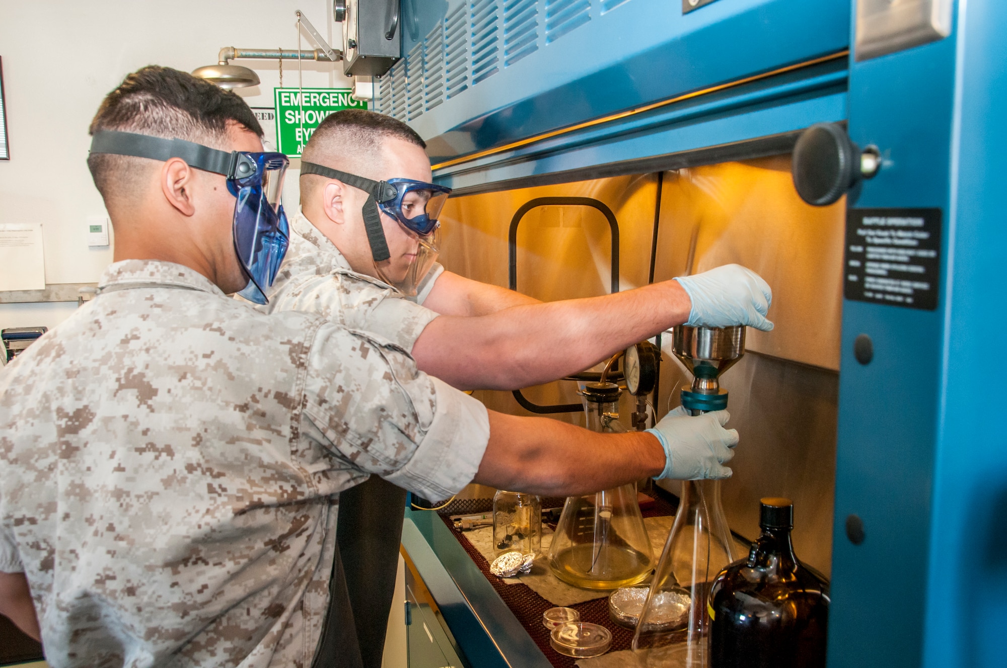 The role of a fuel specialist does not always include outside work on the flight line or driving a massive tanker. In a lab at the petroleum, oils and lubricant shop attached to the 162nd Fuels Management Flight, Marine Corps Cpl. Jesse Storey and Lance Cpl. Paul Robledogarcia tests fuel samples by using controlled bottle methods, ensuring its purity meets pre-established technical orders. Beginning in late March and ending in early June, the Marines will be training and executing operational tasks at the 162nd Wing. (U.S Air National Guard Photo by Tech. Sgt. Erich B. Smith/Released)