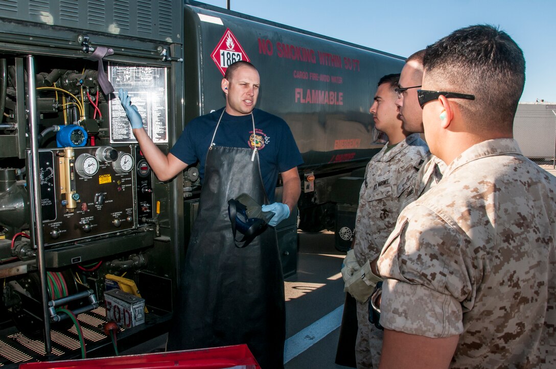 Air Force Staff Sgt. Scott Frank of the Fuels Management Flight at the 162nd Wing describes how fuel samples are pulled from a refueling truck’s filtration system to a group of U.S. Marines. Frank said this process is commonly known as the first line of defense in fuels quality control. Beginning in late March and ending in early June, the Marines will be training and executing operational tasks at the 162nd Wing.   (U.S Air National Guard Photo by Tech. Sgt. Erich B. Smith/Released)