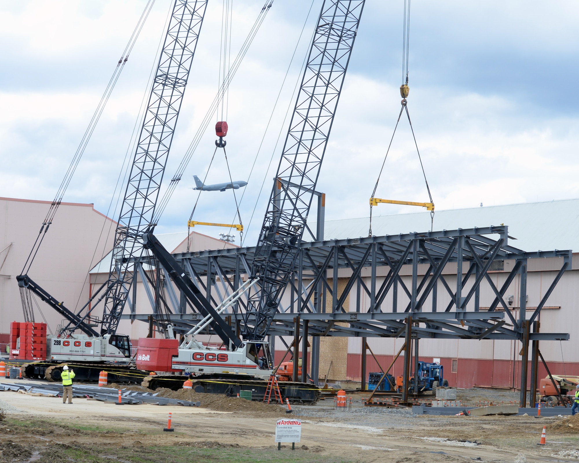 Contractors lift an 80 ton truss into position, Pease Air National Guard Base, N.H., April 8, 2016.  The intent of the construction project is to remodel Buildings 253 and 254 to maximize the operational space in order to promote efficiency and productivity in preparation for the arrival of 12 KC-46A tankers in February 2018. (U.S. Air National Guard photo by Staff Sgt. Curtis J. Lenz) 