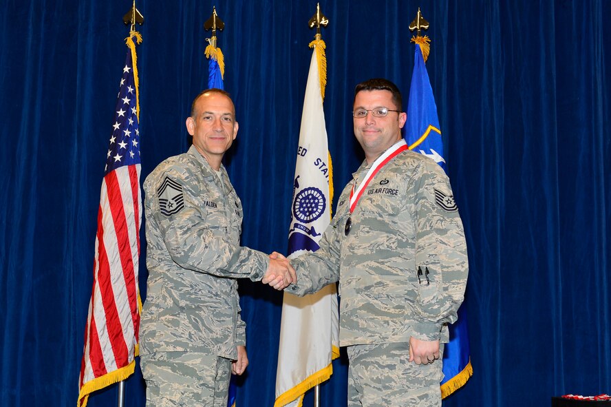 MCGHEE TYSON AIR NATIONAL GUARD BASE, Tenn. -  Tech. Sgt. Jonathan Tucker, right, receives the Distinguished Graduate medallion from Chief Master Sgt. Edward L. Walden Sr., commandant of the Paul H. Lankford Enlisted PME Center, here, March 30, 2016, at the I. G. Brown Training and Education Center. (U.S. Air National Guard photo by Master Sgt. Jerry D. Harlan/Released)