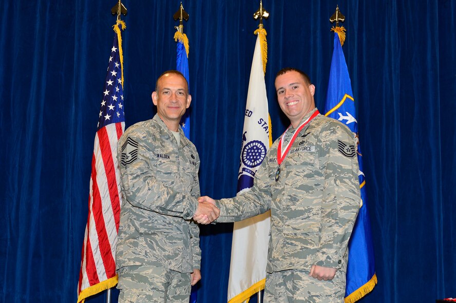 MCGHEE TYSON AIR NATIONAL GUARD BASE, Tenn. -  Tech. Sgt. Jose Rodriugez, right, receives the Distinguished Graduate medallion from Chief Master Sgt. Edward L. Walden Sr., commandant of the Paul H. Lankford Enlisted PME Center, here, March 30, 2016, at the I. G. Brown Training and Education Center. (U.S. Air National Guard photo by Master Sgt. Jerry D. Harlan/Released)