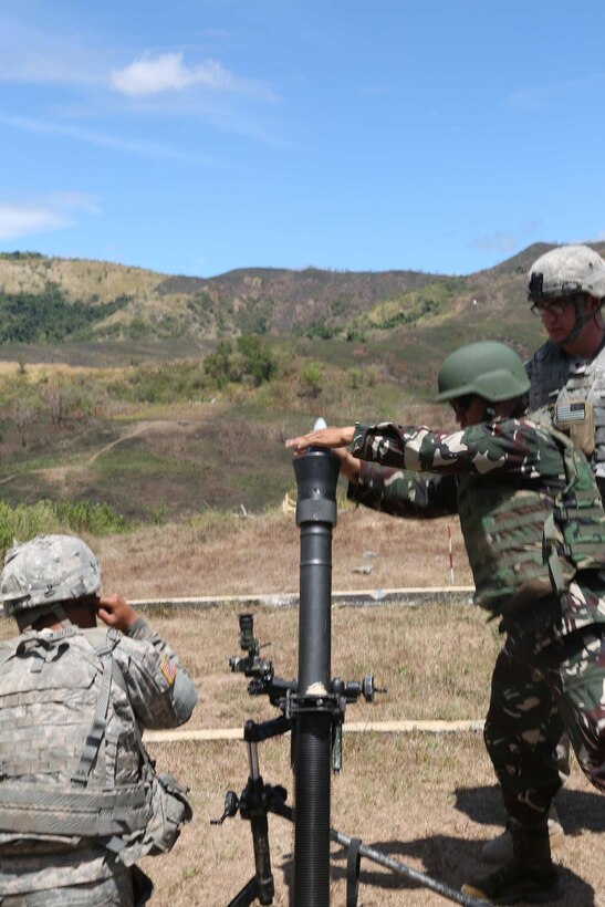 U.S. Soldiers assigned to Headquarters and Headquarters Company, 2nd Battalion, 3rd Infantry Regiment, 1-2 Stryker Brigade Combat Team, and a Filipino soldier assigned to 3rd Battalion, 7th Infantry Division, Armed Forces of the Philippines, prepare to fire an M252 81mm mortar, at Fort Magsaysay, Philippines, April 7, 2016. This was part of Balikatan 16, an annual training exercise between U.S.  and Philippine forces intended to enhance military-to-military relations and combined combat capabilities.