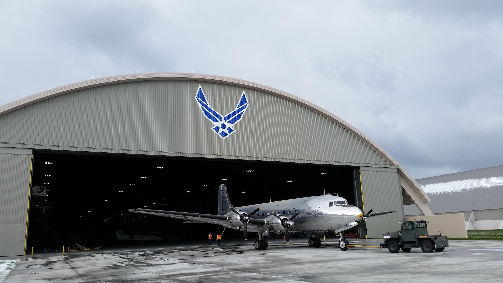 DAYTON, Ohio -- The VC-54C Sacred Cow being towed into the fourth building at the National Museum of the United States Air Force on April 9, 2016. (U.S. Air Force photo by Rob Bardua)