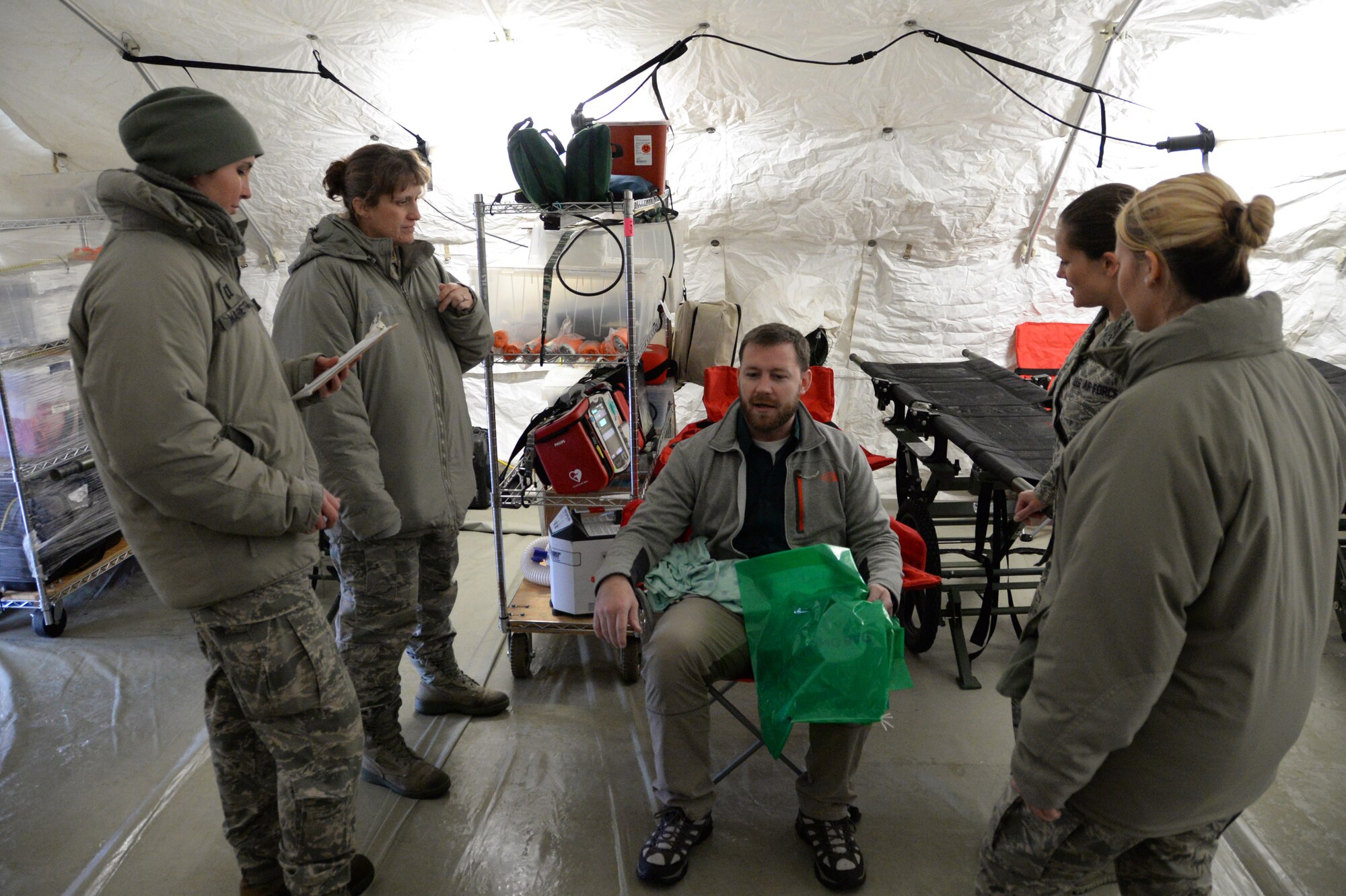 U.S. Air Force Airmen with the Indiana Air National Guard assigned to the 19th CBRNE Enhanced Response Force Package, 181st Intelligence Wing, treat a victim of a simulated chemical explosion outside of the Munson Healthcare Grayling Hospital in Grayling, Mich., April 6, 2016. (U.S. Air National Guard photo by Airman 1st Class Kevin D. Schulze)
