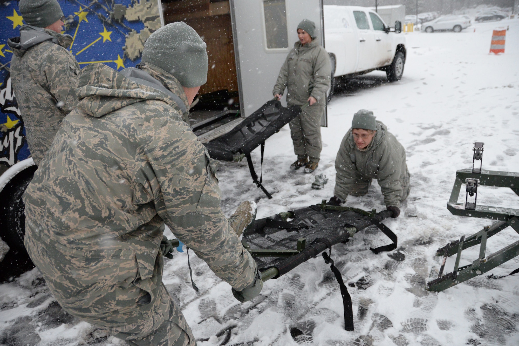 U.S. Air Force Airmen with the Indiana Air National Guard assigned to the 19th CBRNE Enhanced Response Force Package, 181st Intelligence Wing, assemble medical stretchers in preparation for a simulation treating victims outside of the Munson Healthcare Grayling Hospital in Grayling, Mich., April 6, 2016. (U.S. Air National Guard photo by Airman 1st Class Kevin D. Schulze)