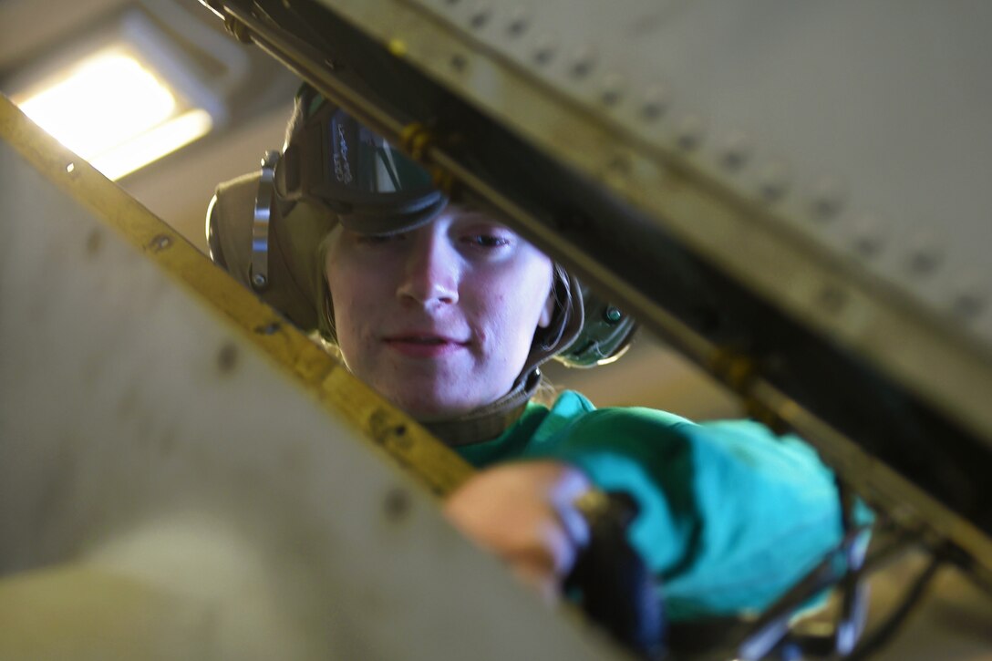 Navy Airman Rachel Clowdis inspects an MH-60S Sea Hawk aboard the amphibious assault ship USS Wasp in the Atlantic Ocean, April 9, 2016. Clowdis is assigned to Helicopter Sea Combat Squadron 22. Navy photo by Petty Officer 1st Class Eric S. Garst