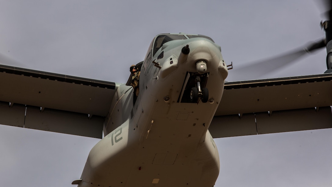 A crew chief with Marine Medium Tiltrotor Squadron 165 “White Knights” looks out of a window aboard an MV-22B Osprey while conducting a confined area landing in Southern California, April 5. Each aircraft had at least two crew chiefs who acted as extensions of the pilots eyes and communicated the presence of potential hazards, the distance and location or nearby aircraft and the Osprey’s approximate distance from the ground. 