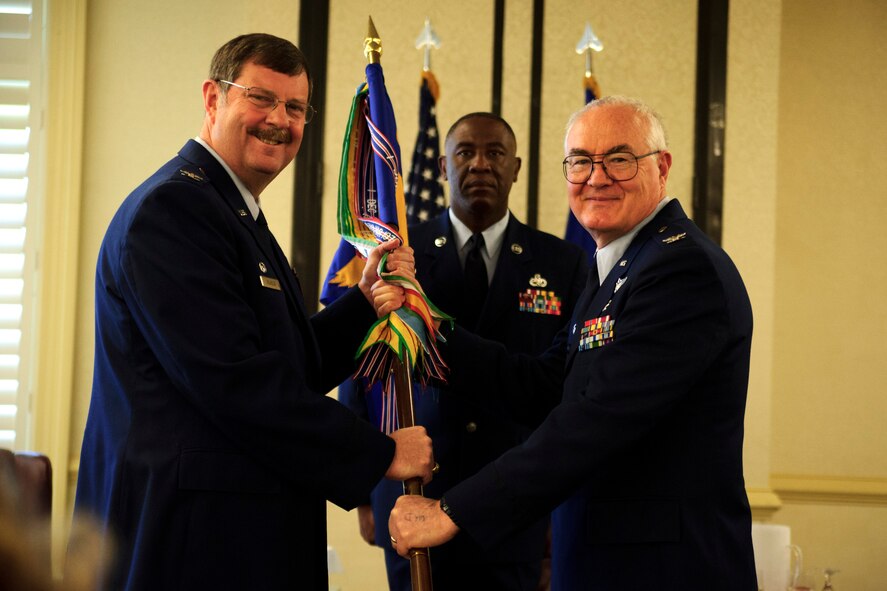 Col. Charles Ellis, outgoing 315th Aerospace Medicine Squadron commander, relinquishes command to Col. Gregory Gilmour, 315th Airlift Wing commander, during a change of command ceremony April 10, 2016. (U.S. Air Force photo by Senior Airman Jonathan Lane/Released).
