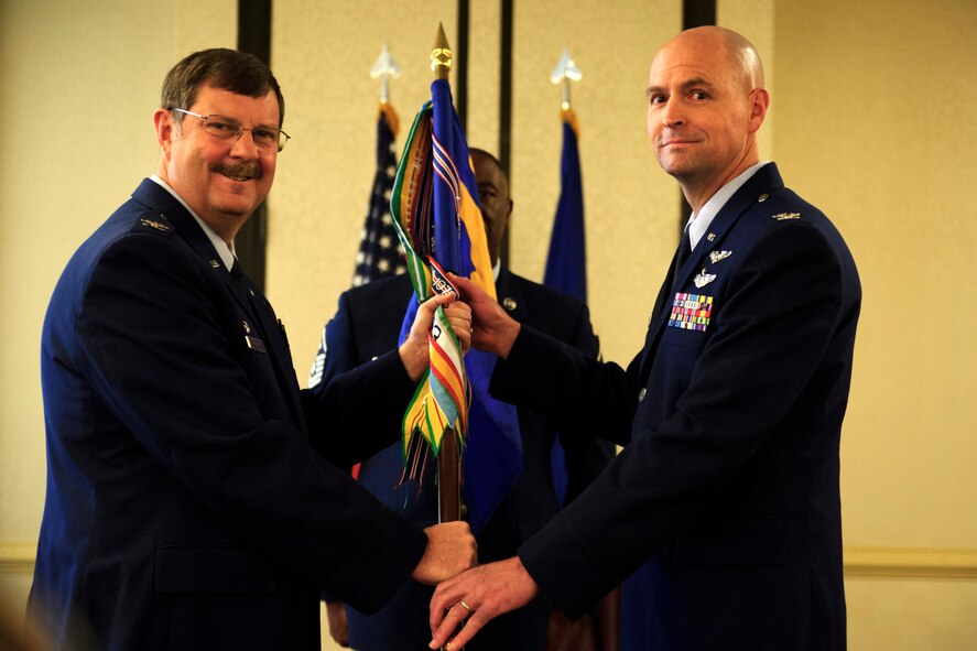 Col. Edwin Newman, incoming 315th Aerospace Medicine Squadron commander, takes command from Col. Gregory Gilmour, 315th Airlift Wing commander, during a change of command ceremony April 10, 2016. (U.S. Air Force photo by Senior Airman Jonathan Lane/Released).