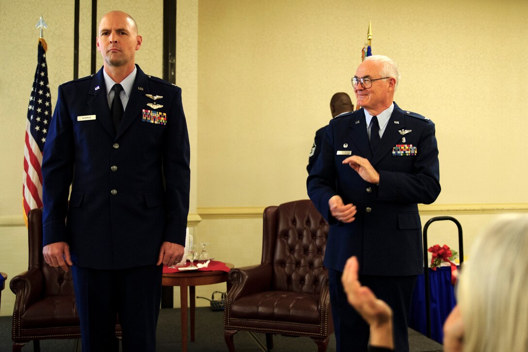 Col. Charles Ellis, outgoing 315th Aerospace Medicine Squadron commander, applauds Col. Edwin Newman, incoming commander, during a change of command ceremony April 10, 2016. (U.S. Air Force photo by Senior Airman Jonathan Lane/Released).