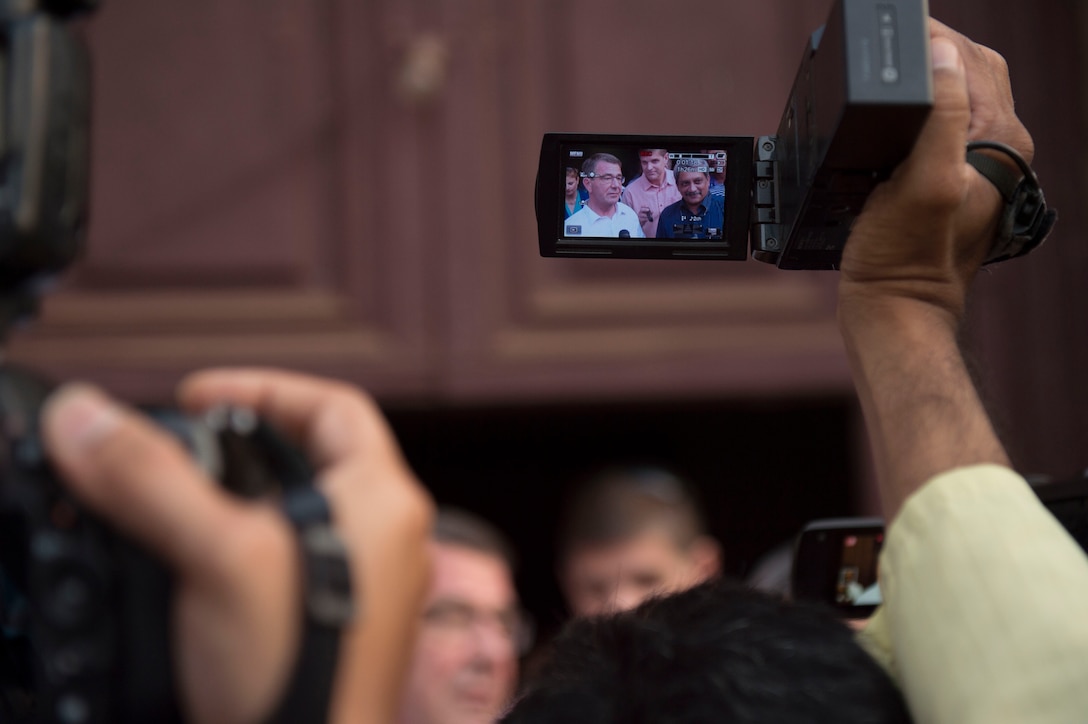 Defense Secretary Ash Carter is seen through a viewfinder as he speaks with reporters after touring the Mangeshi Temple with Indian Defense Minister Manohar Parrikar, right, in Goa, India, April 10, 2016. Carter is visiting India to solidify the rebalance to the Asia-Pacific region. DoD photo by Air Force Senior Master Sgt. Adrian Cadiz