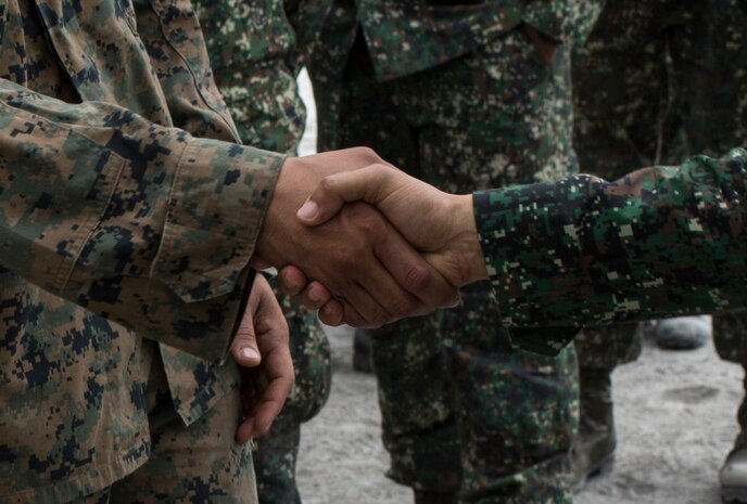 U.S. Marine Sgt. Eric Rosarioayla, section chief, 1st Battalion, 10th Marine Regiment, 2nd Marine Division shakes hands with Philippine Marine Maj. Gen. Remigio Valdez, Philippine Commandant, at Crow Valley, Philippines, April 8, 2016. U.S. and Philippine Marines trained together on firing procedures for the M777 Howitzer to build their combined capabilities. Balikatan is an annual Philippines-U.S. military bilateral training exercise that is a signature element of the Philippine-U.S. alliance focused on a variety of missions to include humanitarian assistance maritime law enforcement, and environment protection. 