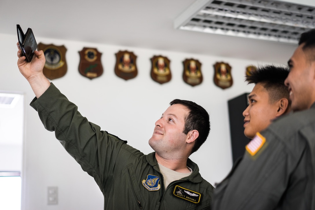 U.S. Air Force 1st Lt. Scott Brooks, 36th Airlift Squadron C-130 pilot, takes a photo with Philippine Air Force pilots from the 220th Airlift Wing during Exercise Balikatan on Mactan-Benito Ebuen Air Base, Philippines, April 7, 2016. Pilots and loadmasters from Yokota Air Base’s 36th AS shared their airflifting knowledge during an all day training session. 