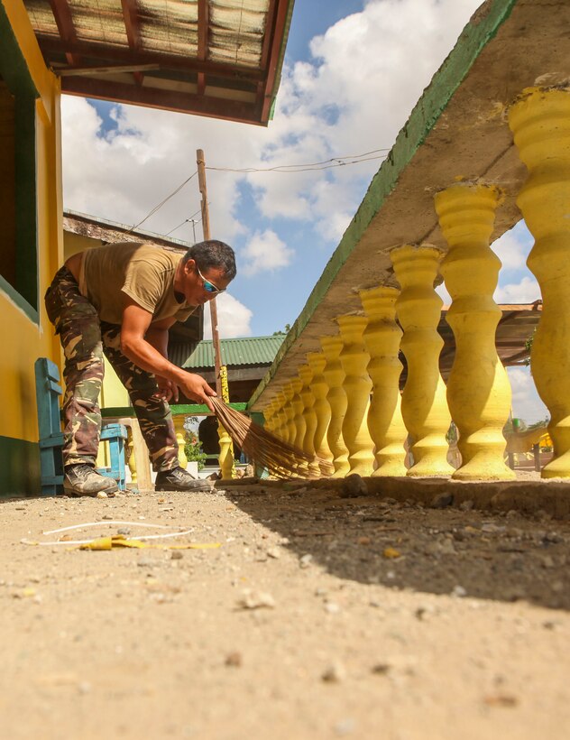 Philippine army soldier Pvt. Rabe Eadao, assigned to 552 Engineer Construction Battalion, sweeps away dirt from a classroom porch during construction at Matangharon Elementary School during a Humanitarian Civic Assistant (HCA)  project at Matangharon Elementary School in Iloilo, Philippines, as part of Exercise Balikatan 2016, April 9, 2016. The construction project is one of multiple HCAs taking place during this year's exercise, designed to improve the quality of life for the local populace and strengthen the bond between our two nations. Balikatan, which means "shoulder to shoulder" in Filipino, is an annual bilateral training exercise aimed at improving the ability of Philippine and U.S. military forces to work together during planning, contingency and humanitarian assistance and disaster relief operations. 