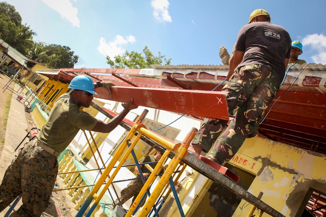U.S. Marine Corps Pfc. Domique Alexander, assigned to 9th Engineer Support Battalion passes over perlins being used as supports during a Humanitarian Civic Assistant (HCA)  project at Matangharon Elementary School in Iloilo, Philippines, as part of Exercise Balikatan 2016, April 9, 2016. The construction project is one of multiple HCAs taking place during this year's exercise, designed to improve the quality of life for the local populace and strengthen the bond between our two nations. Balikatan, which means "shoulder to shoulder" in Filipino, is an annual bilateral training exercise aimed at improving the ability of Philippine and U.S. military forces to work together during planning, contingency and humanitarian assistance and disaster relief operations. 