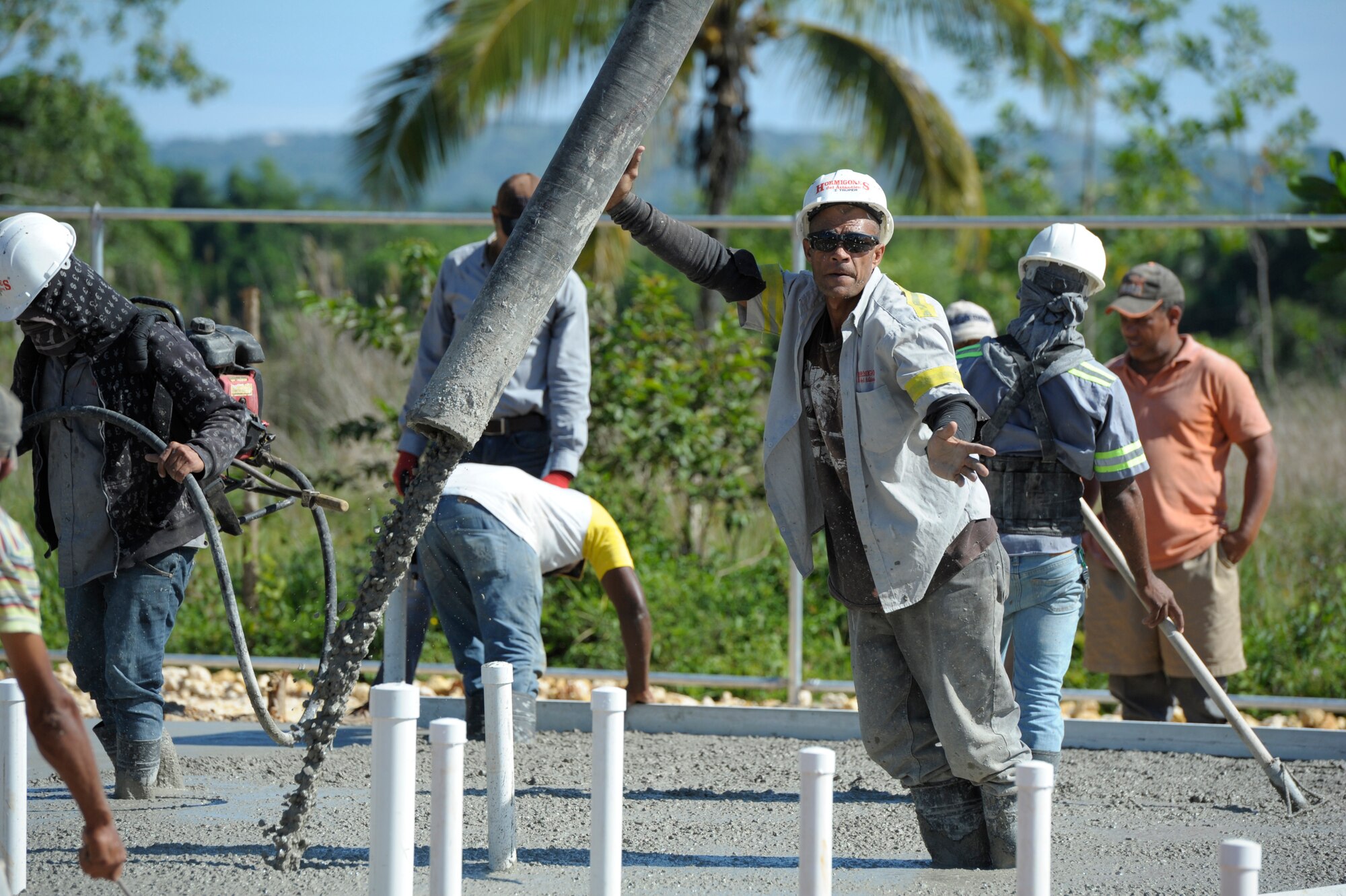 Dominican contractors fill a foundation with concrete for a clinic being built in Copeyito, Dominican Republic as part of Exercise NEW HORIZONS 2016, Apr. 7, 2016. NEW HORIZONS provides essential training to U.S. forces and allows them to remain prepared for real-world deployments in support of contingency, humanitarian assistance and disaster relief operations. (U.S. Air Force photo by Master Sgt. Chenzira Mallory/Released)