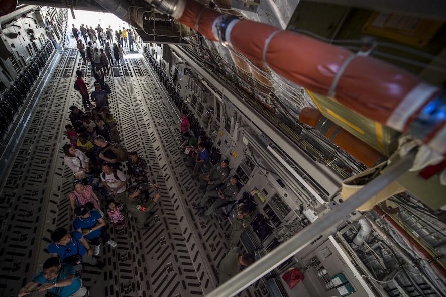 Philippine locals wait in line to see the cockpit of a C-17 Globemaster III from the 15th Wing, Hickam Air force Base, Hawaii during the static display at Clark Air Base, Philippines, April 9, 2016. U.S. military and Armed Forces of the Philippines hosted the event displaying various aircraft from all U.S. services and the Philippine Air Force. This year marks the 32nd iteration of Balikatan where U.S. service members continue to work “shoulder-to-shoulder” with members of the Armed Forces of the Philippines to increase combined readiness to crises and conflict across the Indo-Asia-Pacific region. (U.S. Air Force photo by Tech. Sgt. Araceli Alarcon/Released)