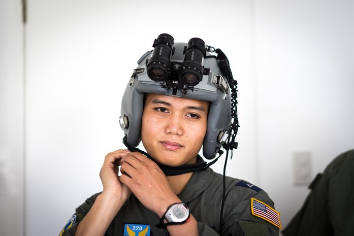 Philippine Air Force 2nd Lt. Rald Pinca, 220th Airlift Wing pilot, tries on a flight helment during an Exercise Balikatan training session on Mactan-Benito Ebuen Air Base, Philippines, April 7, 2016. Pinca recently graduated flight school and plans on being a C-130 pilot. (U.S. Air Force photo by Staff Sgt. Michael Smith/ Released)