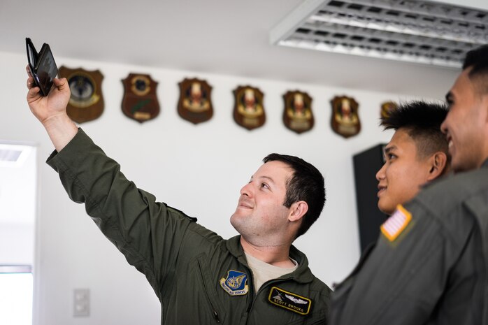 U.S. Air Force 1st Lt. Scott Brooks, 36th Airlift Squadron C-130 pilot, takes a photo with Philippine Air Force pilots from the 220th Airlift Wing during Exercise Balikatan on Mactan-Benito Ebuen Air Base, Philippines, April 7, 2016. Pilots and loadmasters from Yokota Air Base’s 36th AS shared their airflifting knowledge during an all-day training session. (U.S. Air Force photo by Staff Sgt. Michael Smith/Released)