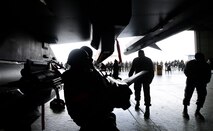 Airmen from the 36th Aircraft Maintenance Unit load an AIM-9 Sidewinder onto an F-16 Fighting Falcon during a quarterly weapons load competition April 8, 2016, at Osan Air Base, Republic of Korea. Weapons load teams from the 25th and 36th AMUs competed by loading three training bombs and one missile onto their respective aircraft during the event. (U.S. Air Force photo by Senior Airman Dillian Bamman/Released) 