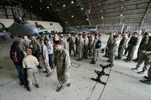 Attendees shake hands with competitors after a quarterly weapons load competition April 8, 2016, at Osan Air Base, Republic of Korea. Weapons load teams from the 25th and 36th Aircraft Maintenance Units competed in dress and appearance, timing and technical order accuracy during the competition. (U.S. Air Force photo by Senior Airman Dillian Bamman/Released)