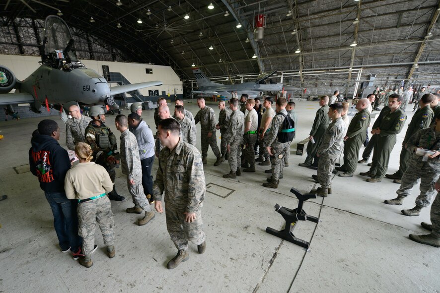 Attendees shake hands with competitors after a quarterly weapons load competition April 8, 2016, at Osan Air Base, Republic of Korea. Weapons load teams from the 25th and 36th Aircraft Maintenance Units competed in dress and appearance, timing and technical order accuracy during the competition. (U.S. Air Force photo by Senior Airman Dillian Bamman/Released)