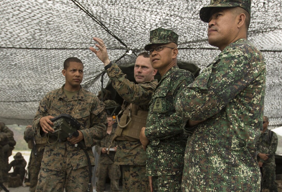 U.S. Marine Col. J.C. Lewis, commanding officer 12th Marine Regiment, 3rd Marine Division, III Marine Expeditionary Force discuss the employment of the M777 Howitzer during Balikatan 16 to Philippine Marine Maj. Gen. Remigio Valdez, Philippine Commandant, at Crow Valley, Philippines, April 8, 2016. U.S. and Philippine Marines trained together on firing procedures for the M777 Howitzer to build their combined capabilities. Balikatan is an annual Philippines-U.S. military bilateral training exercise that is a signature element of the Philippine-U.S. alliance focused on a variety of missions to include humanitarian assistance maritime law enforcement, and environment protection. 