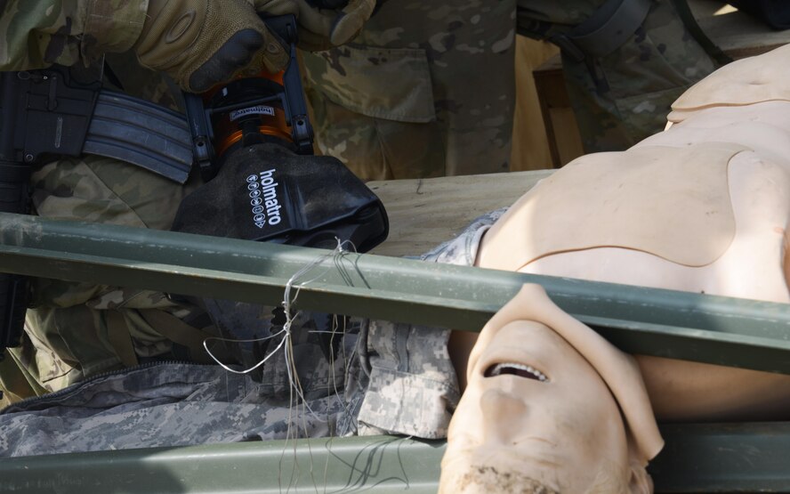 A U.S. Army Joint Security Area Security Battalion fire team member uses the Jaws of Life to rescue a simulated trapped service member during a joint search and recovery exercise April 8, 2016, at Camp Bonifas, Republic of Korea. The Jaws of Life is a hydraulic device that is used to pry apart the wreckage of crashed vehicles or aircraft to free people trapped inside. 51st Civil Engineer Squadron fire prevention firefighters assisted in the exercise by teaching ROK and U.S. Soldiers how to safely enter a crashed aircraft to rescue individuals. (U.S. Air Force photo by Senior Airman Dillian Bamman/Released)