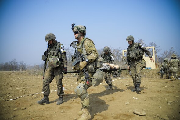 South Korea and U.S. Army Joint Security Area Security Battalion fire team members perform a four-man carry of a simulated injured service member during a joint search and recovery exercise April 8, 2016, at Camp Bonifas, South Korea. 51st Civil Engineer Squadron fire prevention firefighters assisted in the exercise by teaching South Korea and U.S. Soldiers how to safely enter a crashed aircraft to rescue individuals. (U.S. Air Force photo/Senior Airman Dillian Bamman)