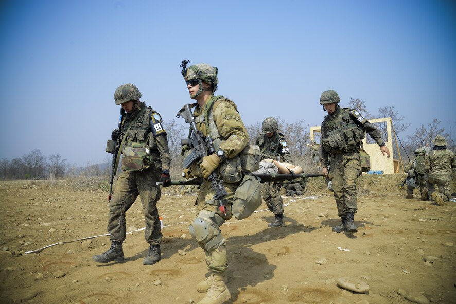 Republic of Korea and U.S. Army Joint Security Area Security Battalion fire team members four-man carry a simulated injured service member during a joint search and recovery exercise April 8, 2016, at Camp Bonifas, Republic of Korea. 51st Civil Engineer Squadron fire prevention firefighters assisted in the exercise by teaching ROK and U.S. Soldiers how to safely enter a crashed aircraft to rescue individuals. (U.S. Air Force photo by Senior Airman Dillian Bamman/Released)