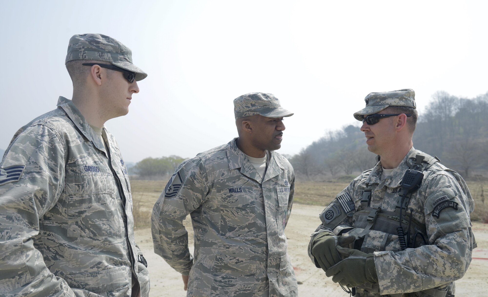 U.S. Air Force Staff Sgt. Eric Gayoso, 51st Civil Engineer Squadron fire prevention crew chief, and Master Sgt. Darnell Walls, 51st CES NCO in charge of training, speak with U.S. Army Lt. Col. Christopher Nyland, Joint Security Area Security Battalion commander, during a joint search and recovery exercise April 8, 2016, at Camp Bonifas, Republic of Korea. 51st CES fire prevention firefighters assisted in the exercise by teaching ROK and U.S. Soldiers how to safely enter a crashed aircraft to rescue individuals. (U.S. Air Force photo by Senior Airman Dillian Bamman/Released)