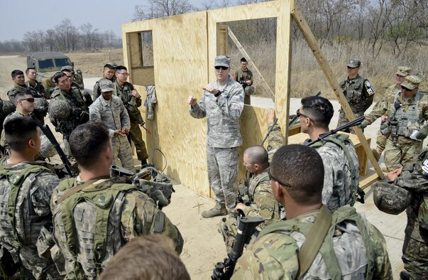 U.S. Air Force Staff Sgt. Eric Gayoso, center, a 51st Civil Engineer Squadron fire prevention crew chief, briefs members of the Joint Security Area Security Battalion on aircraft extraction techniques during a joint search and recovery exercise April 8, 2016, at Camp Bonifas, South Korea. The firefighters assisted with the exercise by teaching South Korea and U.S. Soldiers on how to enter crashed aircraft by cutting through with specialized equipment including a circular saw and Jaws of Life. (U.S. Air Force photo/Senior Airman Dillian Bamman)