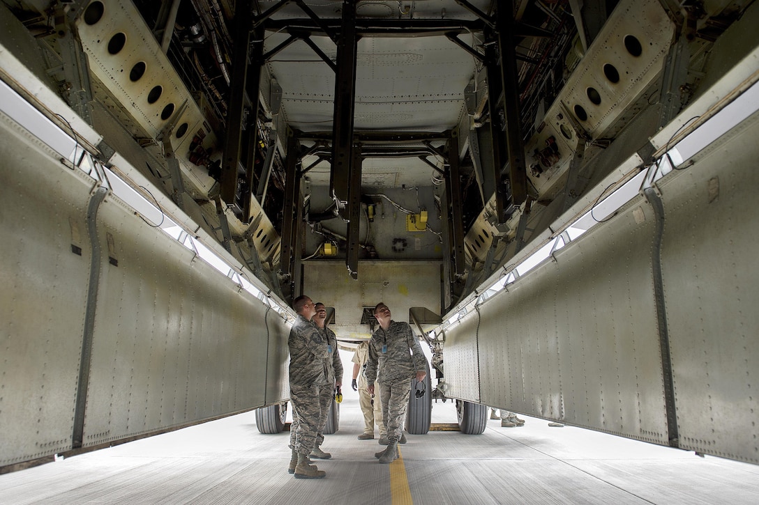 Airmen inspect the bomb bay of a B-52 Stratofortress aircraft at Al Udeid Air Base, Qatar, April 9, 2016. The airmen are assigned to the 20th Expeditionary Bomb Squadron, deployed from Barksdale Air Force Base, La. Air Force photo by Tech. Sgt. Nathan Lipscomb