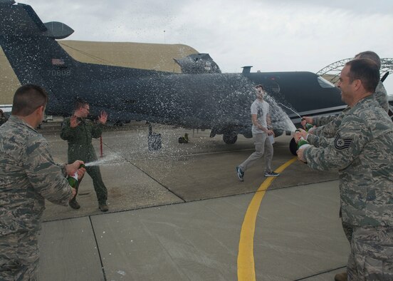 Staff Sgt. Kyle Cook, a tactical system operator with the 28th Intelligence Squadron, gets doused after completing his aircraft mission qualification training March 31 at Hurlburt Field, Florida. The completion of that training pushed the squadron to its goal of achieving full operational capability ahead of schedule. (U.S. Air Force photo/Airman 1st Class Kai White)