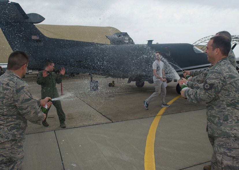 Staff Sgt. Kyle Cook, a tactical system operator with the 28th Intelligence Squadron, gets doused after completing his aircraft mission qualification training March 31 at Hurlburt Field, Florida. The completion of that training pushed the squadron to its goal of achieving full operational capability ahead of schedule. (U.S. Air Force photo/Airman 1st Class Kai White)