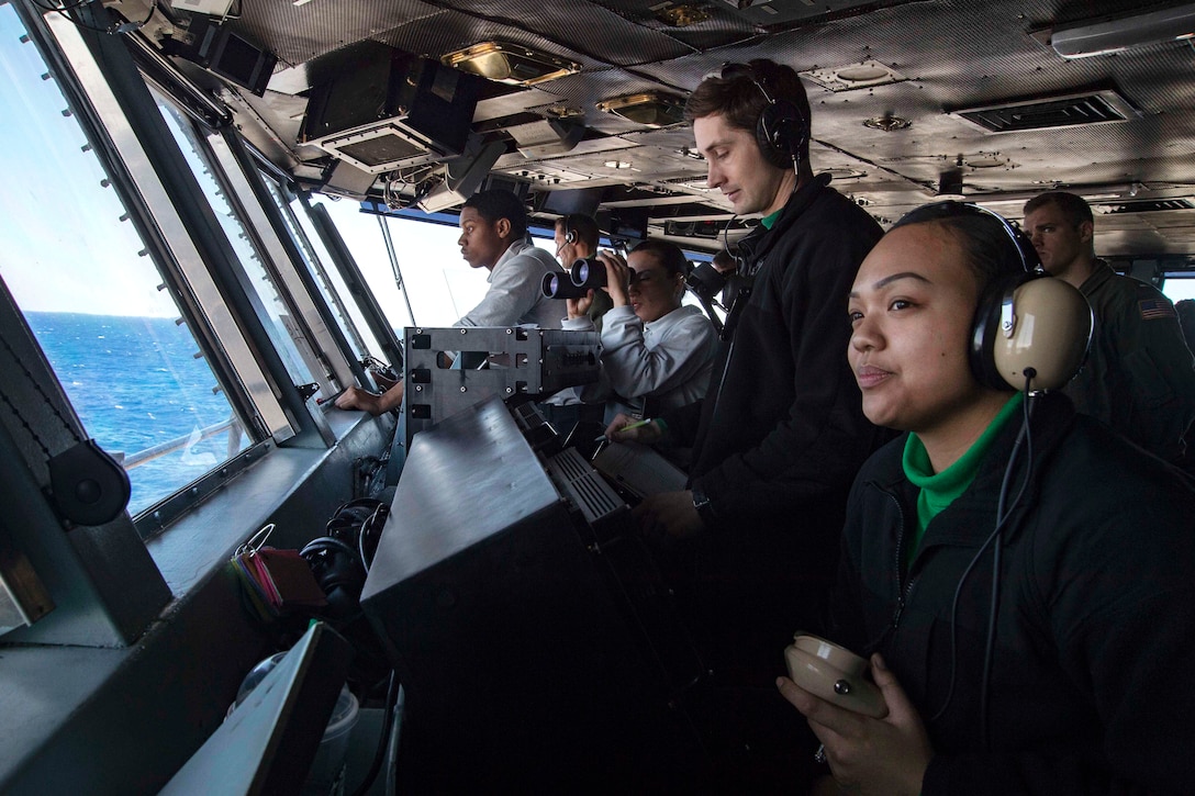 Sailors observe flight operations from the primary flight control of the aircraft carrier USS Dwight D. Eisenhower in the Atlantic Ocean, April 3, 2016. Navy photo by Seaman Apprentice Casey S. Trietsch