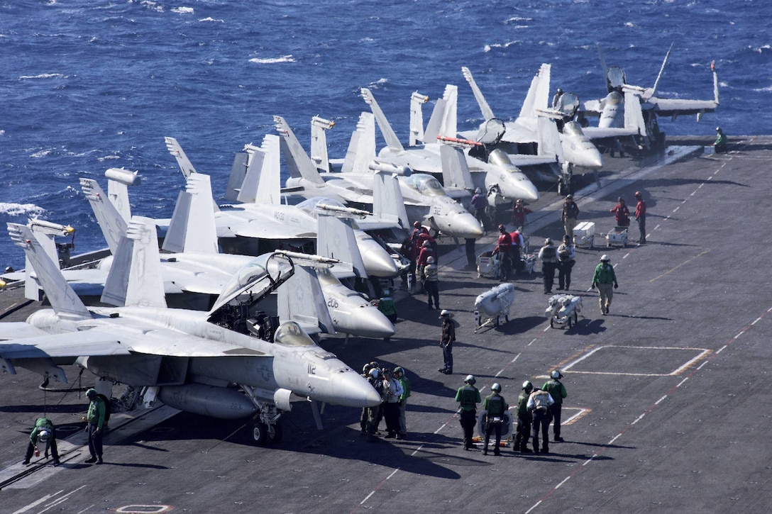 Sailors prepare for flight operations on the flight deck of the aircraft carrier USS Dwight D. Eisenhower in the Atlantic Ocean, April 3, 2016. Navy photo by Petty Officer 3rd Class Michael R. Gendron